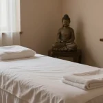 Experience a soothing massage at https://www.makangs.com/ in a serene one-person spa room with calming candles and aromatherapy.